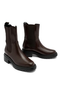 Brązowe skórzane botki za kostkę z elastycznymi panelami bocznymi, masywną czarną podeszwą i gładkim wykończeniem. Zaprojektowane z myślą o łatwości zakupu i trwałości.