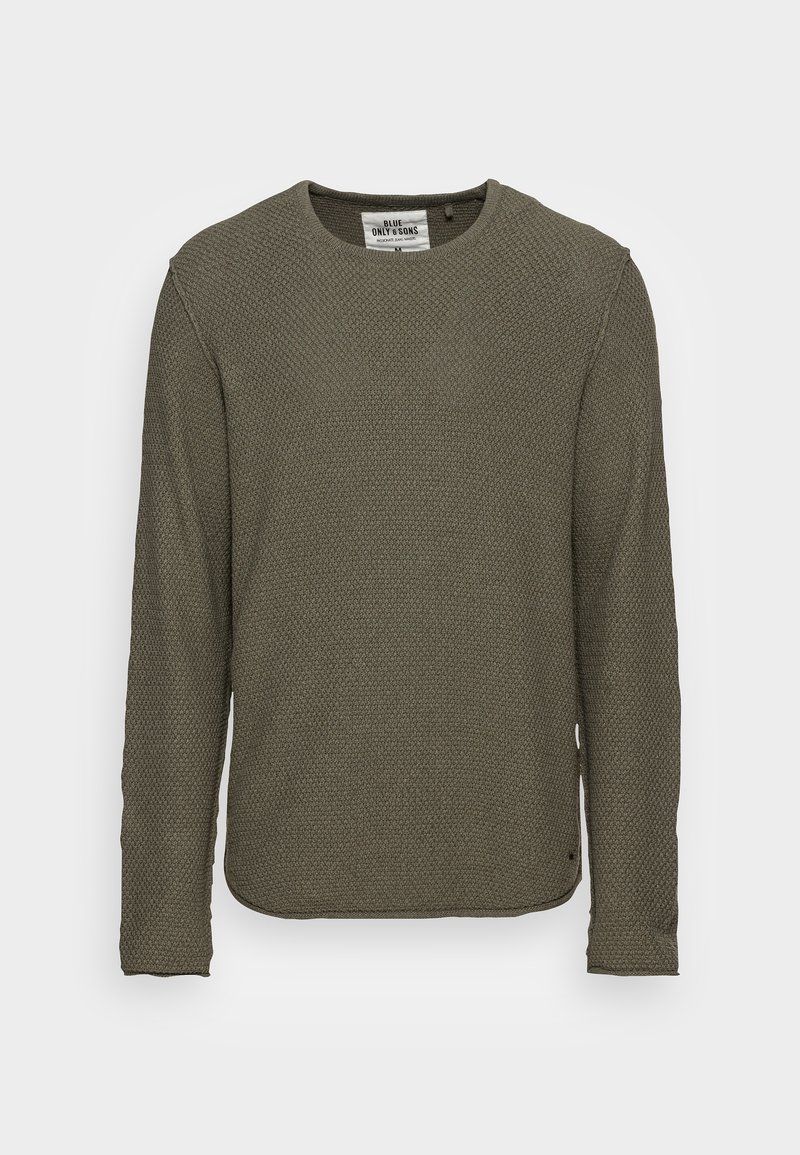 Pull à manches longues vert olive en maille texturée. Dispose d'un col rond et d'ouvertures sur les côtés à l'ourlet. Étiquette positionnée à l'intérieur.