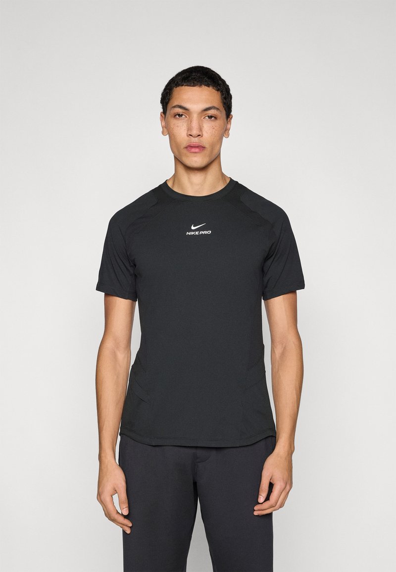 Black short-sleeve athletic shirt with moisture-wicking fabric, featuring a crew neckline and Nike Pro logo in white at the center chest.