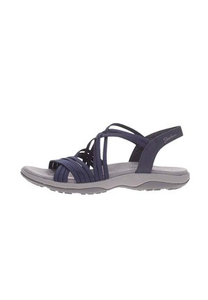 Skechers sandals feature a dark navy upper with woven straps, a cushioned gray insole, and a flexible outsole designed for comfort.