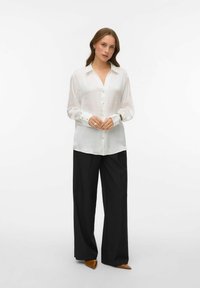 White button-up shirt with a collar and long sleeves, paired with black wide-leg trousers. The fabric appears lightweight and slightly glossy.
