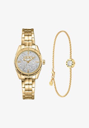 Goudkleurig DKNY-horloge met wijzerplaat bezet met kristallen en bijpassende gouden schakelarmband met een kristalaccent en DKNY-logo hanger.
