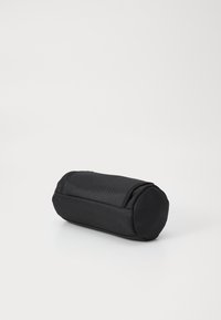 Black cylindrical bag with textured material, zip closure, and rounded ends. Compact design suitable for various items.