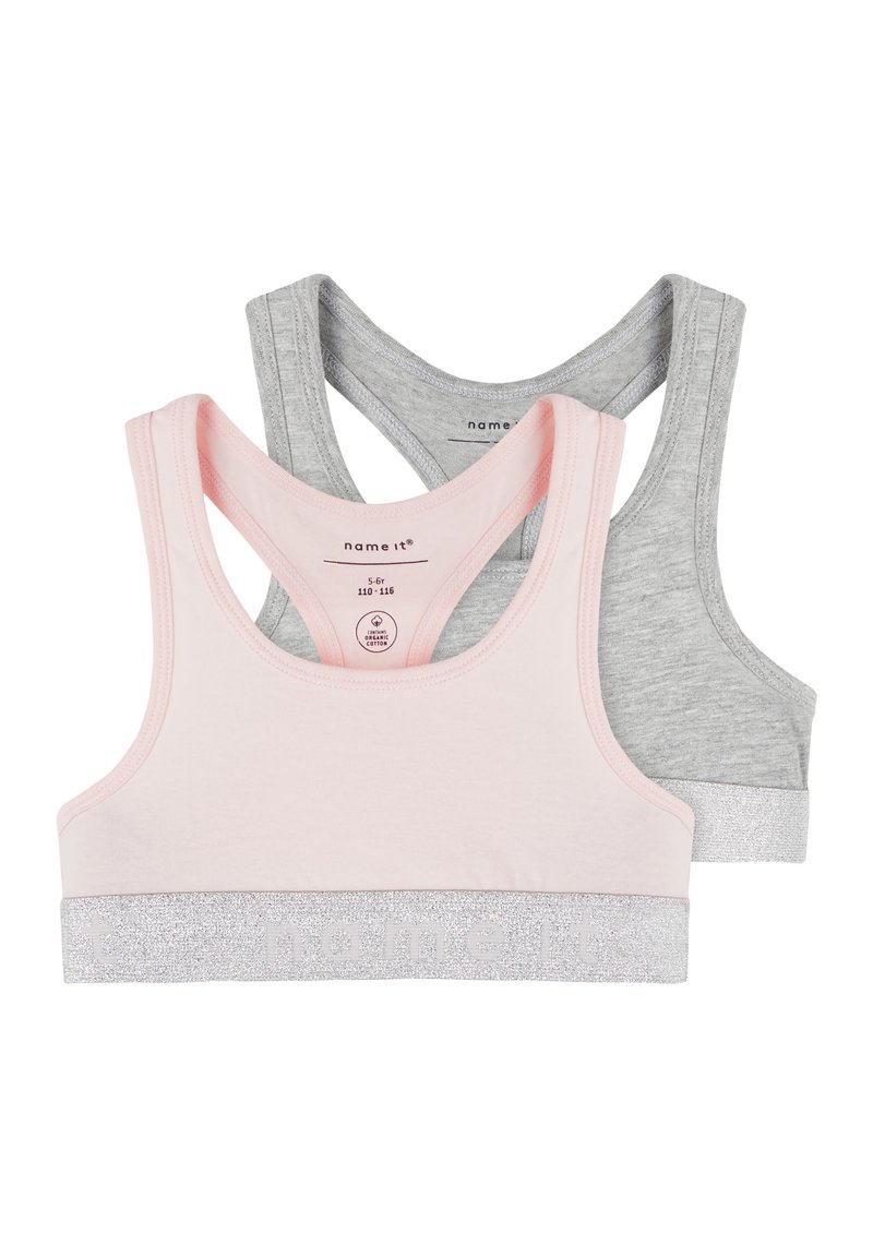 Two crop tops: one in light pink with a silver glitter band, the other in grey with a matching silver band. Both feature a racerback design.