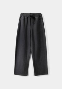 Tmavě šedé tepláky s elastickým pasem, šňůrkou a dvěma bočními kapsami. Vyrobené z měkké látky s uvolněným, širokým střihom.