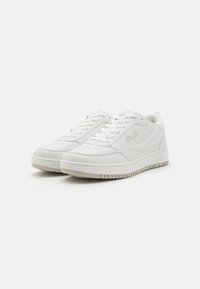 White athletic sneakers with a smooth leather upper, lacing system, perforated toe box, and a durable rubber outsole. Simple logo detail on the side.