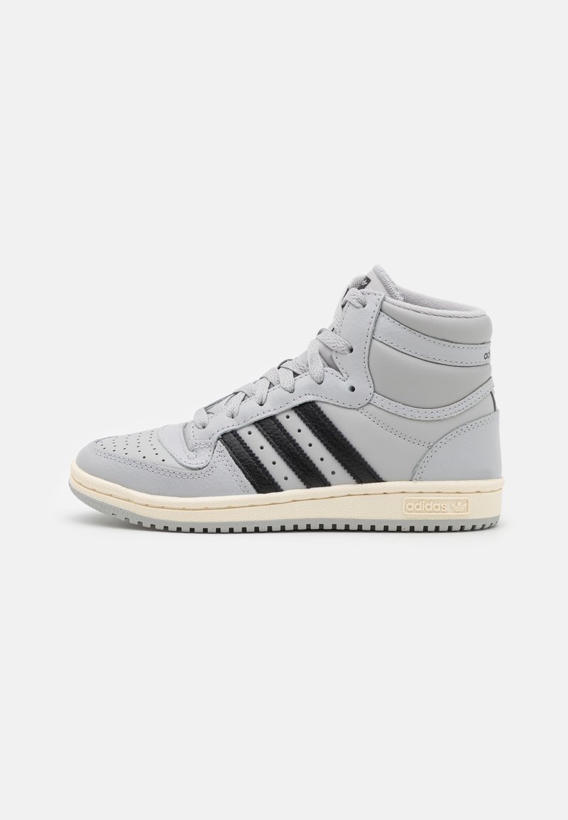 High-top sneakers in light gray leather with black stripes, perforated toe, and off-white rubber sole. Features cushioned collar and logo accent.