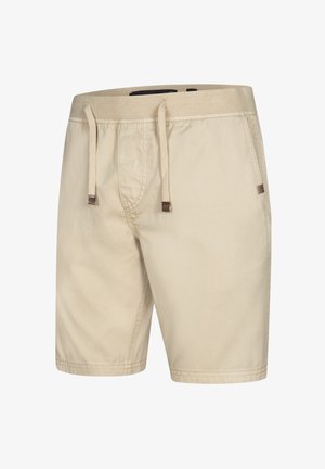 Beige shorts laget av lett stoff, med snøring i livet, to sidelommer og en jevn tekstur.