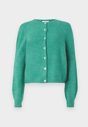Grønn ullkardigan med rund hals og lange ermer. Har knapper foran og ribbestrikkede mansjetter og nederkant. Myk tekstur.