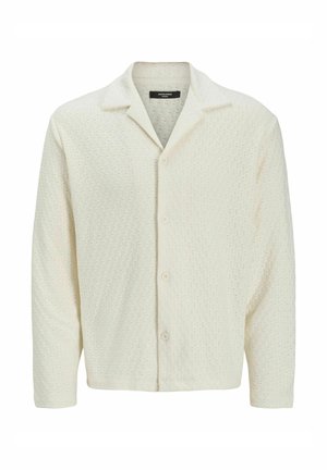Light cream button-up shirt made of textured fabric with a diamond pattern, featuring a spread collar and long sleeves.