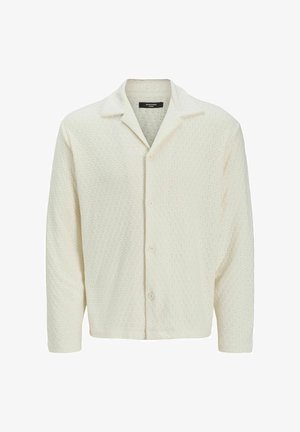 Light cream button-up shirt made of textured fabric with a diamond pattern, featuring a spread collar and long sleeves.