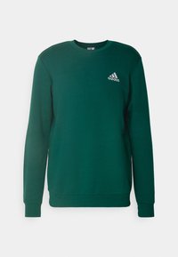 Zelená mikina vyrobená z bavlněné směsi, s kulatým výstřihem, dlouhými rukávy a malým bílým logem Adidas na hrudi.