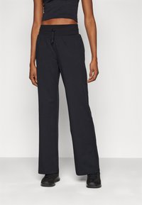 Under Armour MOTION OPEN PANT - Treningo apatinė dalis - black/white