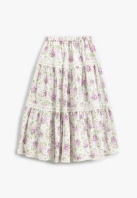 Jupe florale blanche avec des roses violettes et des accents verts. Comprend des couches superposées et une dentelle le long de la taille et des niveaux. Ceinture élastique.