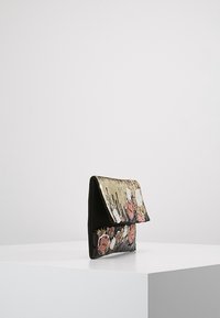 Schwarze und goldene Falt-Clutch aus strukturiertem Material, mit floralen Mustern in Pink, Weiß und goldenen Akzenten auf der Vorderseite.