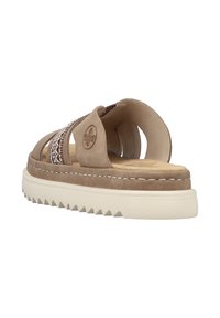 Beige suede sandal with an open back, decorative woven strap, and a beige rubber sole featuring a serrated edge for traction.