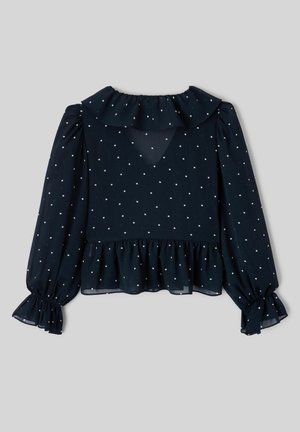 Blouse à manches longues bleu marine à pois blancs, col à volants et ourlet à volants aux poignets et à la taille.