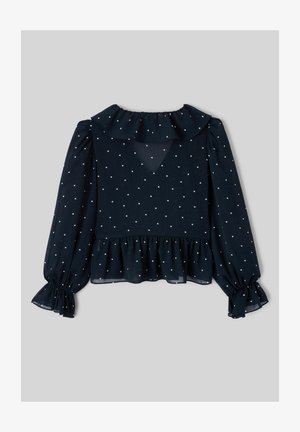 Blouse à manches longues bleu marine à pois blancs, col à volants et ourlet à volants aux poignets et à la taille.