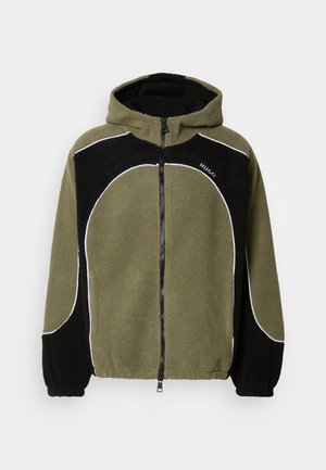 Fleece hooded jacket in olive green and black, featuring a zip front, elastic cuffs, and white accent stitching. Textured fabric.