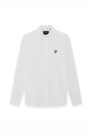 Λευκό μακρυμάνικο πουκάμισο με κουμπιά, διπλωμένο γιακά και μικρό κίτρινο λογότυπο πουλιού στο αριστερό μέρος του στήθους.