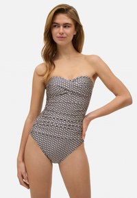 Bañador de una pieza sin tirantes en color azul marino con un estampado floral. Textura suave, diseño entallado y corte moderado en las piernas. Reunido sutil en el busto.