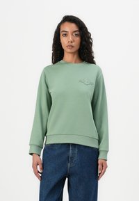 Felpa verde realizzata in morbido tessuto, con scollo rotondo e polsini a coste, caratterizzata da un logo ricamato sul petto.