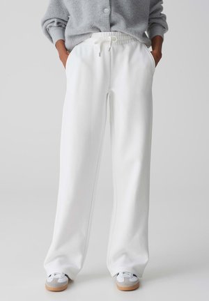 Witte, wijde sweatpants met een elastische tailleband, trekkoorddetail, zijzakken en een gladde, zachte stoftextuur.