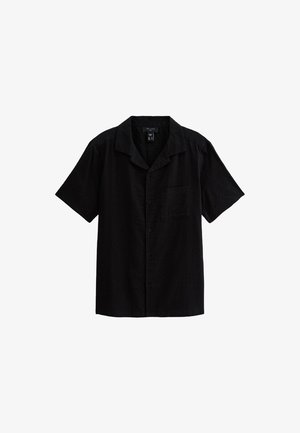 Chemise à manches courtes noire boutonnée en tissu texturé, dotée d'une poche poitrine et d'un col camp.