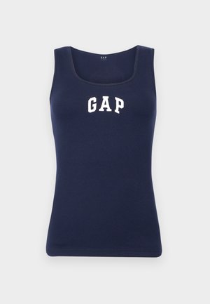 Marineblå ærmeløs ribbet tanktop med rund halsudskæring og hvidt GAP-logo trykt på brystet mod en ensfarvet baggrund.