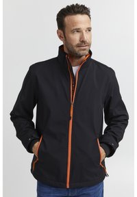 Black jacket with orange zippers and accents, high collar design, two front pockets, and a smooth material texture. Casual fit.