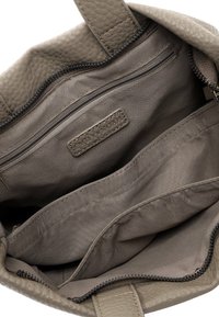 Gray textured leather handbag interior with multiple compartments, including a zippered pocket and a label patch. Smooth fabric lining.