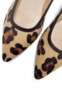 Ballerine con stampa leopardata e punta affusolata. Realizzate in materiale morbido e testurizzato, con un bordo nero lungo il contorno. Toni neutri beige e marroni.