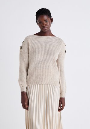 Beige knitted sweater with an off-shoulder design and rib texture. Features decorative buttons on the sleeves, paired with a pleated cream skirt.