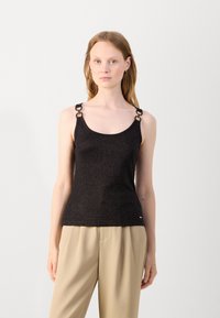 Black tank top with a subtle shimmer, featuring decorative metallic hardware on shoulder straps. Smooth texture and fitted design.