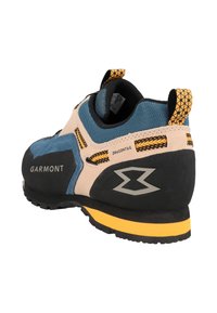 Climbing shoe with a blue, beige, and black design, featuring textured suede and rubber materials, a rubber sole, and mesh accents.
