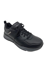Zapatilla deportiva negra de cuero sintético, con diseño de cordones, cuello acolchado, forro de malla ventilada y suela de goma gruesa.