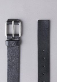 Black leather belt with a silver metal buckle, featuring a textured surface and multiple adjustment holes along the strap.