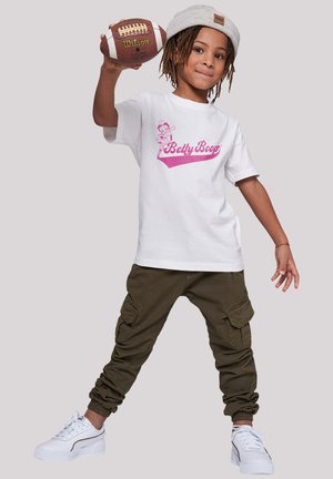White T-shirt featuring a pink Betty Boop graphic, paired with olive green cargo pants and white sneakers with a textured sole.
