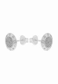 Orecchini a perno in argento con un design circolare, dotati di un centro scintillante e lettere incise lungo il bordo. Texture liscia.