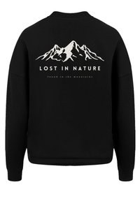 Black sweatshirt featuring white mountain graphic with "LOST IN NATURE" text. Ribbed cuffs and hem, soft texture. Casual fit design.