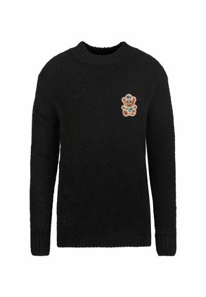 Pull en tricot noir à manches longues et col rond ; présente un patch de ours en peluche coloré sur la poitrine gauche.