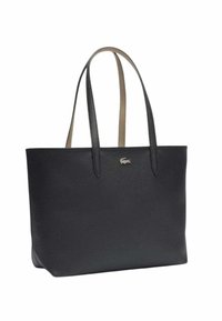 Sac fourre-tout en cuir noir avec une texture lisse, doté de longues anses fines et d'un accent logo subtil. Forme rectangulaire spacieuse.