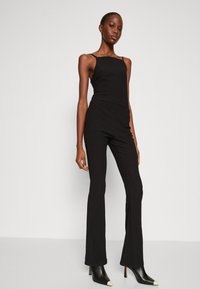 Calvin Klein CRINKLED FLARED - Pantaloni - black