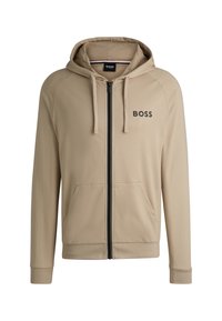 Sudadera con cremallera color beige, con un logo negro en el pecho, bolsillos frontales y capucha ajustable con cordón. Tejido suave y puños acanalados.