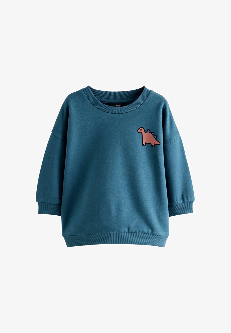 Sudadera azul para niños con un parche de dinosaurio de dibujos animados rosa en la parte superior izquierda del pecho y puños y dobladillo de canalé.
