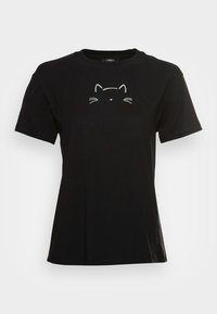 Camiseta de algodón negra con un diseño simple de la cara de un gato blanco en la parte frontal. Manga corta y cuello redondo. Textura suave.