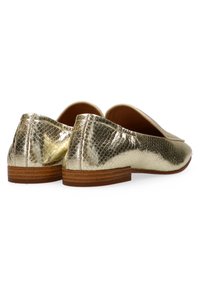 Golden loafers with a snake-print texture, leather material, flat design, and a low wooden heel. Accented with stitching along the edges.