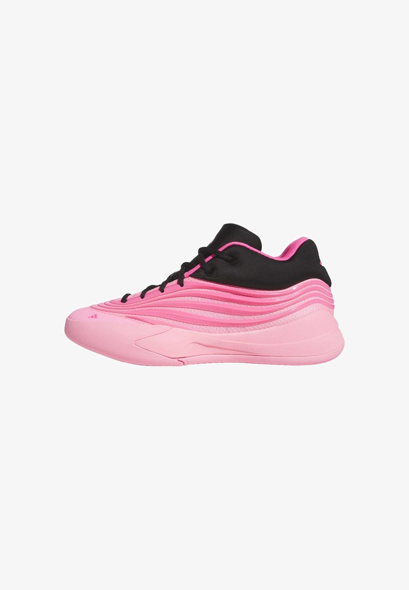 Pink athletic shoe featuring a textured upper, smooth rubber sole, black accents, and a wavy design. Lace-up closure with rounded toe.