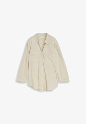 Chemise beige à manches longues avec col et deux poches poitrine, présentée à plat sur fond blanc.