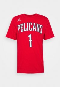 Red T-shirt featuring "PELICANS" in gray lettering, number "1" in the center, and a white Air Jordan logo on the left shoulder.
